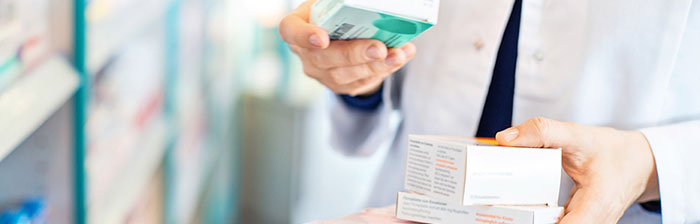 pharmacist hands holding medication boxes